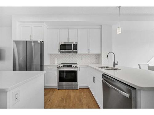 15 Walcrest Row Se, Calgary, AB - Indoor Photo Showing Kitchen With Stainless Steel Kitchen With Double Sink With Upgraded Kitchen