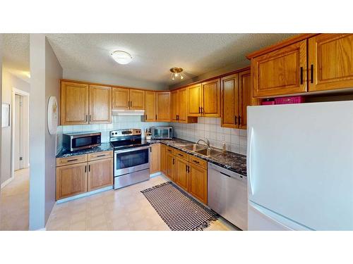 79 Shawmeadows Close Sw, Calgary, AB - Indoor Photo Showing Kitchen With Stainless Steel Kitchen With Double Sink