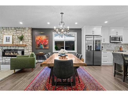 16 Sun Valley Drive Se, Calgary, AB - Indoor Photo Showing Dining Room With Fireplace