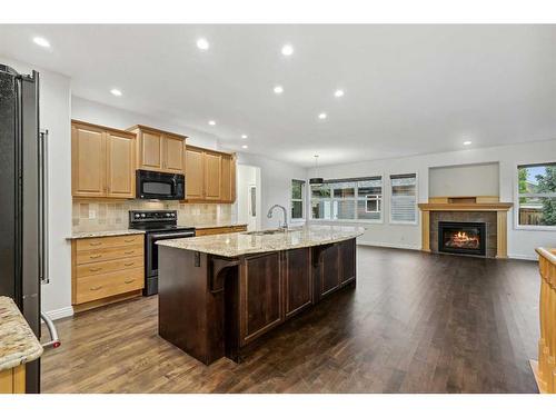 200 Prestwick Manor Se, Calgary, AB - Indoor Photo Showing Kitchen With Fireplace With Stainless Steel Kitchen With Upgraded Kitchen