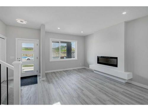 82 Edith Green Nw, Calgary, AB - Indoor Photo Showing Living Room With Fireplace