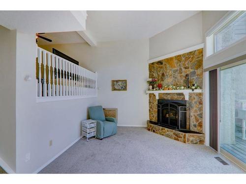 66-23 Glamis Drive Sw, Calgary, AB - Indoor With Fireplace