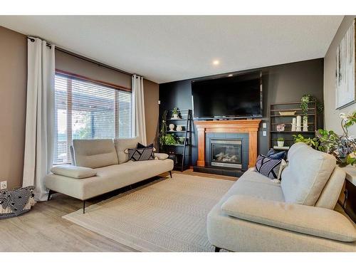 144 Springmere Road, Chestermere, AB - Indoor Photo Showing Living Room With Fireplace