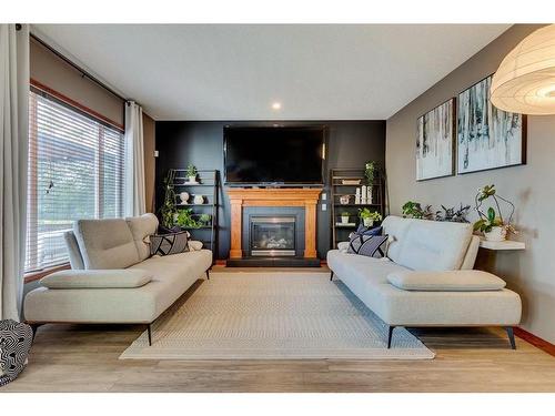 144 Springmere Road, Chestermere, AB - Indoor Photo Showing Living Room With Fireplace