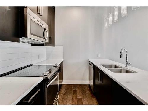 102-1808 27 Avenue Sw, Calgary, AB - Indoor Photo Showing Kitchen With Double Sink With Upgraded Kitchen