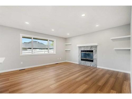 103 Scandia Bay Nw, Calgary, AB - Indoor Photo Showing Living Room With Fireplace