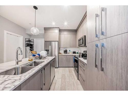 1408-681 Savanna Boulevard Ne, Calgary, AB - Indoor Photo Showing Kitchen With Stainless Steel Kitchen With Double Sink With Upgraded Kitchen