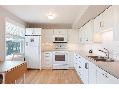 122-4525 31 Street Sw, Calgary, AB - Indoor Photo Showing Kitchen With Double Sink