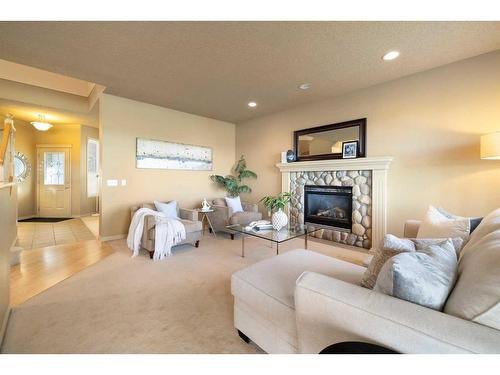 7787 Springbank Way Sw, Calgary, AB - Indoor Photo Showing Living Room With Fireplace