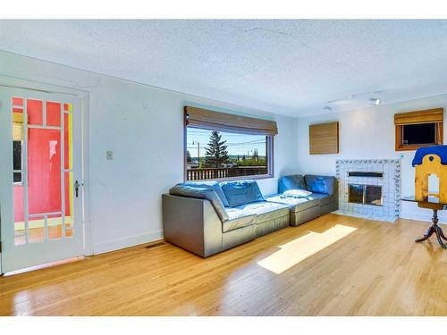 408 3 Street, Cochrane, AB - Indoor Photo Showing Living Room With Fireplace