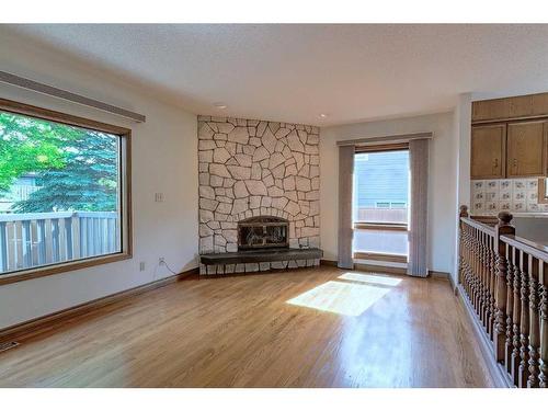 111 Oakmount Way Sw, Calgary, AB - Indoor Photo Showing Living Room With Fireplace