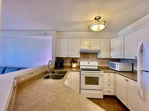 417-3000 Somervale Court Sw, Calgary, AB - Indoor Photo Showing Kitchen With Double Sink