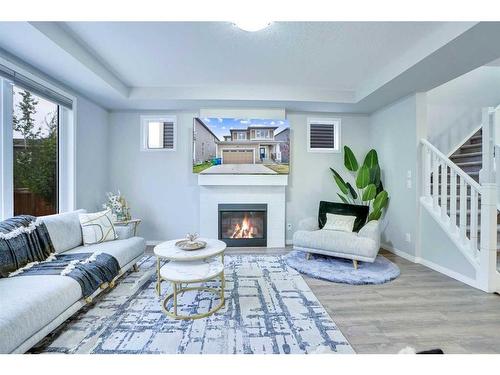 59 Osborne Common Sw, Airdrie, AB - Indoor Photo Showing Living Room With Fireplace