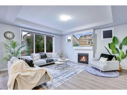 59 Osborne Common Sw, Airdrie, AB - Indoor Photo Showing Living Room With Fireplace