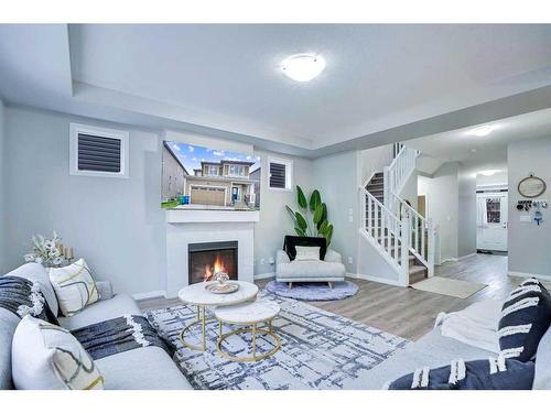 59 Osborne Common Sw, Airdrie, AB - Indoor Photo Showing Living Room With Fireplace