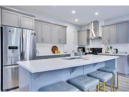 59 Osborne Common Sw, Airdrie, AB - Indoor Photo Showing Kitchen With Double Sink With Upgraded Kitchen