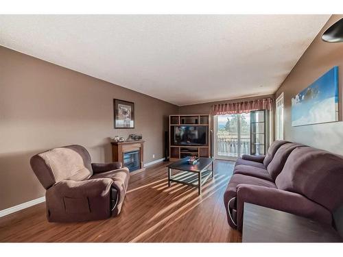 115 Ranchlands Court Nw, Calgary, AB - Indoor Photo Showing Living Room With Fireplace