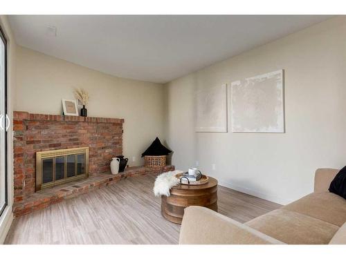 606-2520 Palliser Drive Sw, Calgary, AB - Indoor Photo Showing Living Room With Fireplace