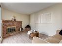 606-2520 Palliser Drive Sw, Calgary, AB  - Indoor Photo Showing Living Room With Fireplace 