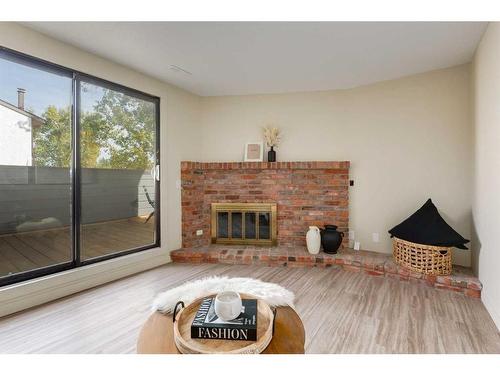 606-2520 Palliser Drive Sw, Calgary, AB - Indoor Photo Showing Living Room With Fireplace