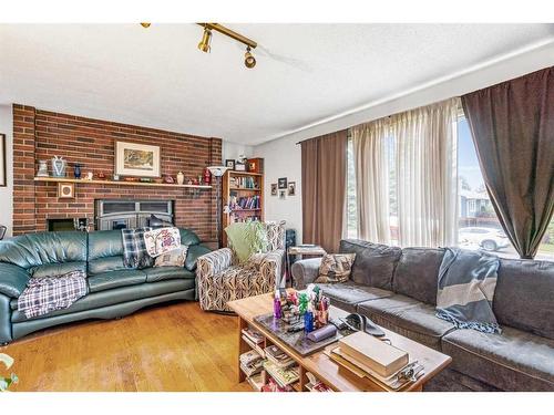 6807 Huntchester Road Ne, Calgary, AB - Indoor Photo Showing Living Room With Fireplace