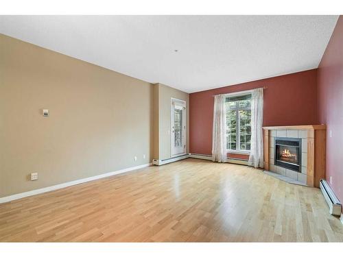 210-5201 Dalhousie Drive Nw, Calgary, AB - Indoor Photo Showing Other Room With Fireplace