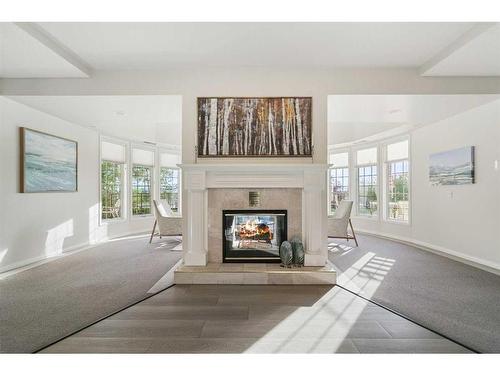 210-5201 Dalhousie Drive Nw, Calgary, AB - Indoor Photo Showing Living Room With Fireplace