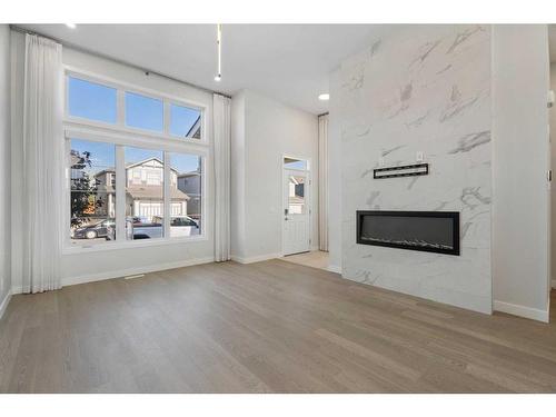 149 Magnolia Terrace Se, Calgary, AB - Indoor Photo Showing Living Room With Fireplace