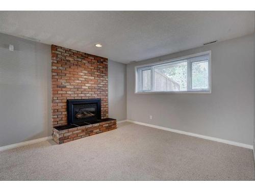 171 Bracewood Way Sw, Calgary, AB - Indoor Photo Showing Living Room With Fireplace