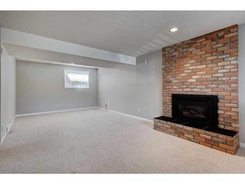 171 Bracewood Way Sw, Calgary, AB - Indoor Photo Showing Other Room With Fireplace