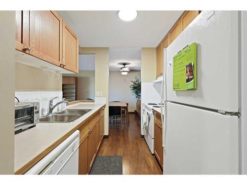 212-550 Westwood Drive Sw, Calgary, AB - Indoor Photo Showing Kitchen With Double Sink