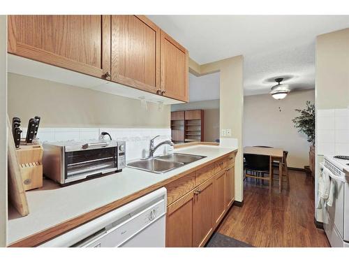 212-550 Westwood Drive Sw, Calgary, AB - Indoor Photo Showing Kitchen With Double Sink