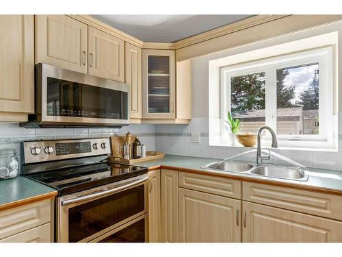 128 Oakridge Place Sw, Calgary, AB - Indoor Photo Showing Kitchen With Stainless Steel Kitchen With Double Sink