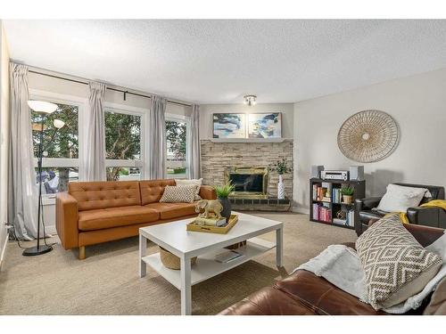 128 Oakridge Place Sw, Calgary, AB - Indoor Photo Showing Living Room With Fireplace