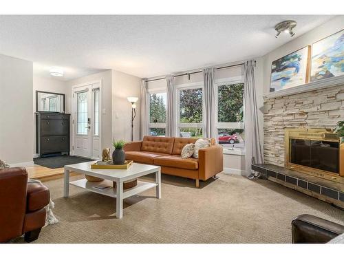 128 Oakridge Place Sw, Calgary, AB - Indoor Photo Showing Living Room With Fireplace