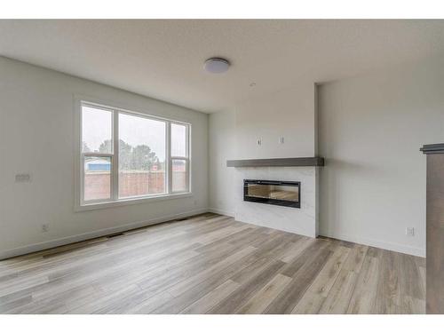 1198 Chinook Winds Circle Sw, Airdrie, AB - Indoor Photo Showing Living Room With Fireplace