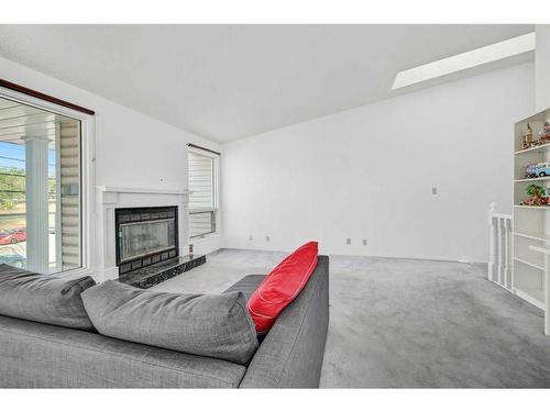 135 Prominence Heights Sw, Calgary, AB - Indoor Photo Showing Living Room With Fireplace