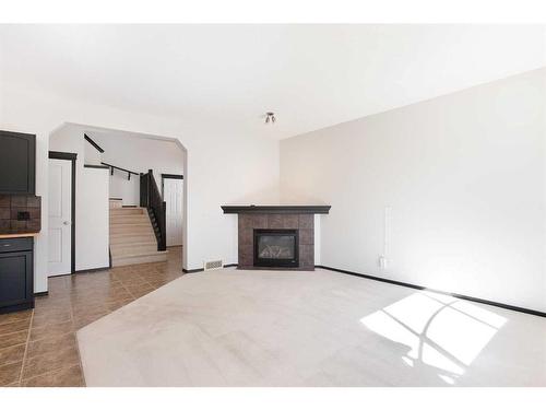 420 Eversyde Way Sw, Calgary, AB - Indoor Photo Showing Living Room With Fireplace