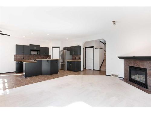 420 Eversyde Way Sw, Calgary, AB - Indoor With Fireplace