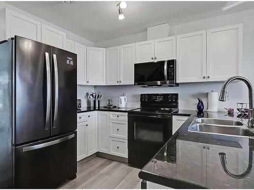 356 Sunrise Terrace Ne, High River, AB - Indoor Photo Showing Kitchen With Double Sink