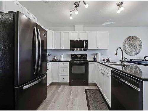 356 Sunrise Terrace Ne, High River, AB - Indoor Photo Showing Kitchen With Double Sink