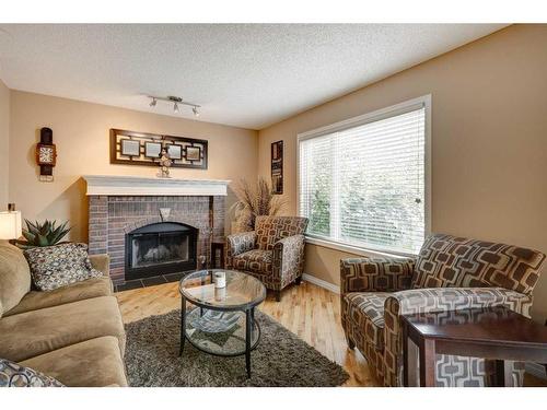 134 Riverwood Crescent Se, Calgary, AB - Indoor Photo Showing Living Room With Fireplace