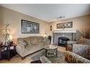 134 Riverwood Crescent Se, Calgary, AB  - Indoor Photo Showing Living Room With Fireplace 