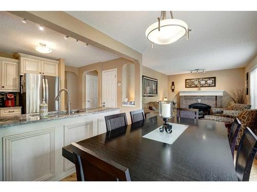 134 Riverwood Crescent Se, Calgary, AB - Indoor Photo Showing Kitchen With Fireplace With Double Sink