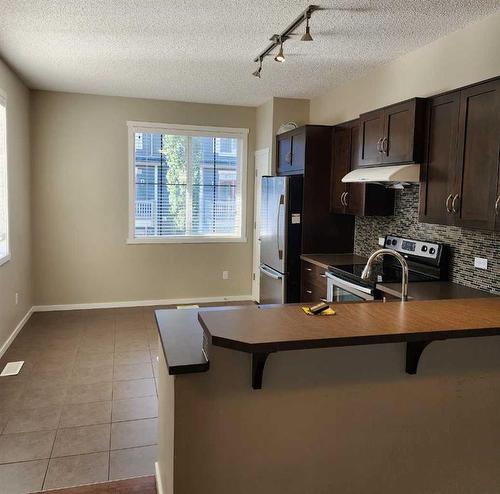 1111-125 Panatella Way Nw, Calgary, AB - Indoor Photo Showing Kitchen With Double Sink