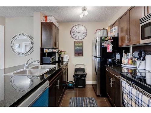 1416-625 Glenbow Drive, Cochrane, AB - Indoor Photo Showing Kitchen With Double Sink