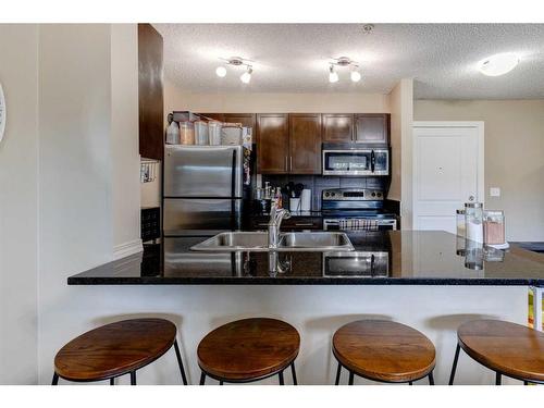 1416-625 Glenbow Drive, Cochrane, AB - Indoor Photo Showing Kitchen With Double Sink