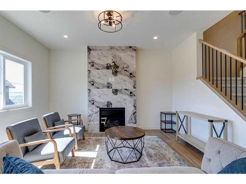 124 Heritage Boulevard, Cochrane, AB - Indoor Photo Showing Other Room With Fireplace