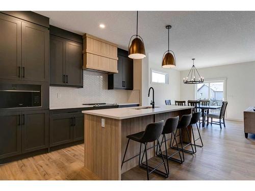 124 Heritage Boulevard, Cochrane, AB - Indoor Photo Showing Kitchen With Upgraded Kitchen