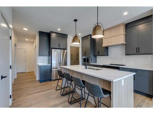 124 Heritage Boulevard, Cochrane, AB - Indoor Photo Showing Kitchen With Double Sink With Upgraded Kitchen